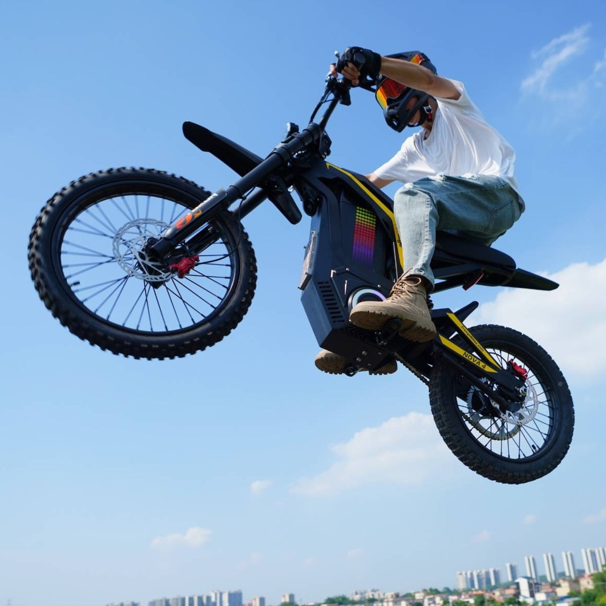 Rider mid-air on Freego Nova4 electric dirt bike, clear sky background