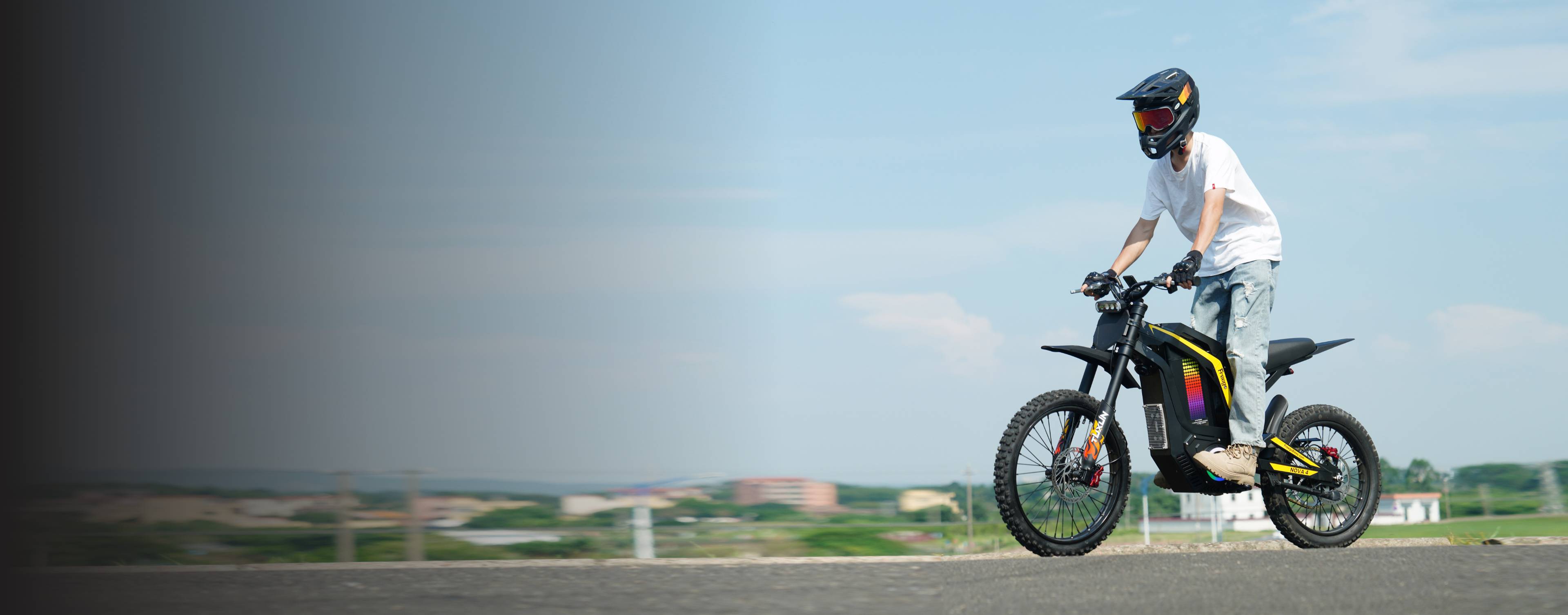 Panoramic shot of rider on Freego Nova4 electric dirt bike with open sky background