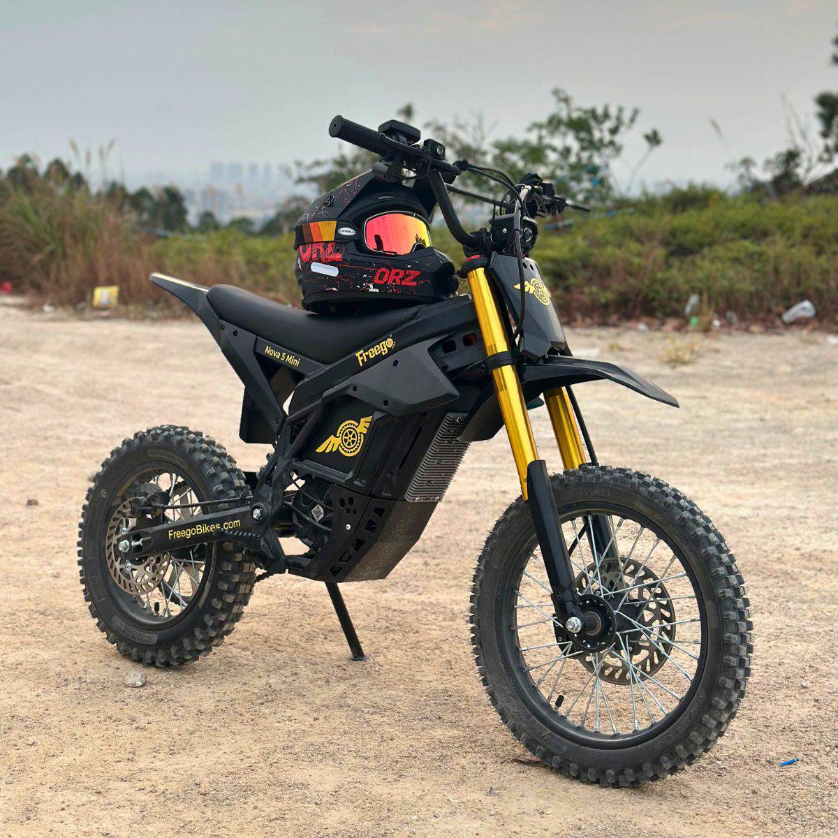 Nova 5 Mini ebike with a helmet on the seat, set against a natural background.