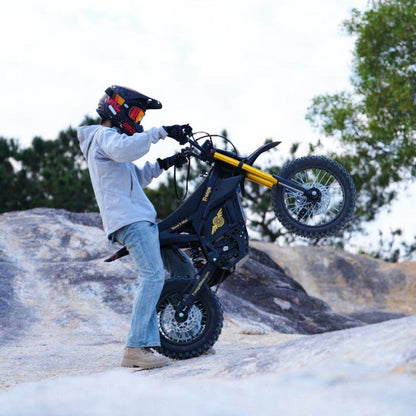 Person on a Nova 5 Mini ebike in a rocky outdoor setting