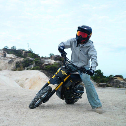Person on a Nova 5 Mini ebike in an outdoor setting with rocky landscape