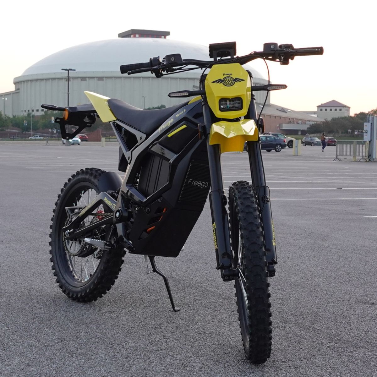 Electric bike with yellow accents in a parking lot