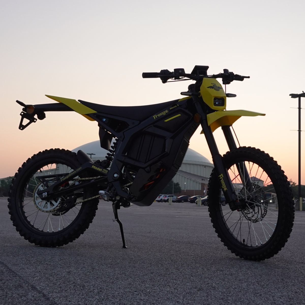 Motorcycle on a road with a sunset or sunrise background