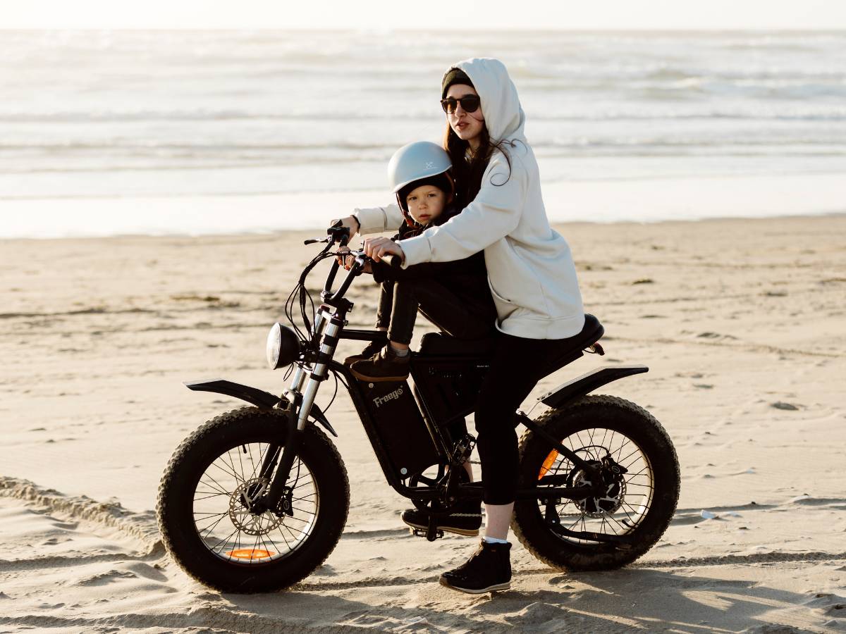 Rider on the Freego S1 ebike riding along a sandy beach.