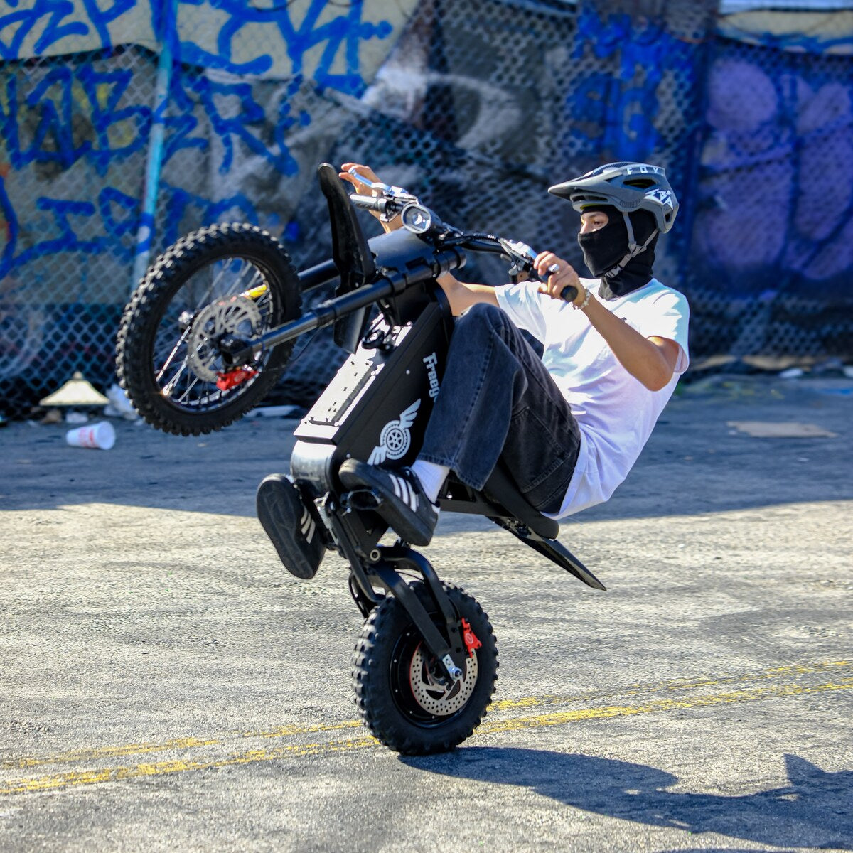Freego X0 Electric Mini Bike for Teens and Adults — rider performing front-wheel wheelie stunt