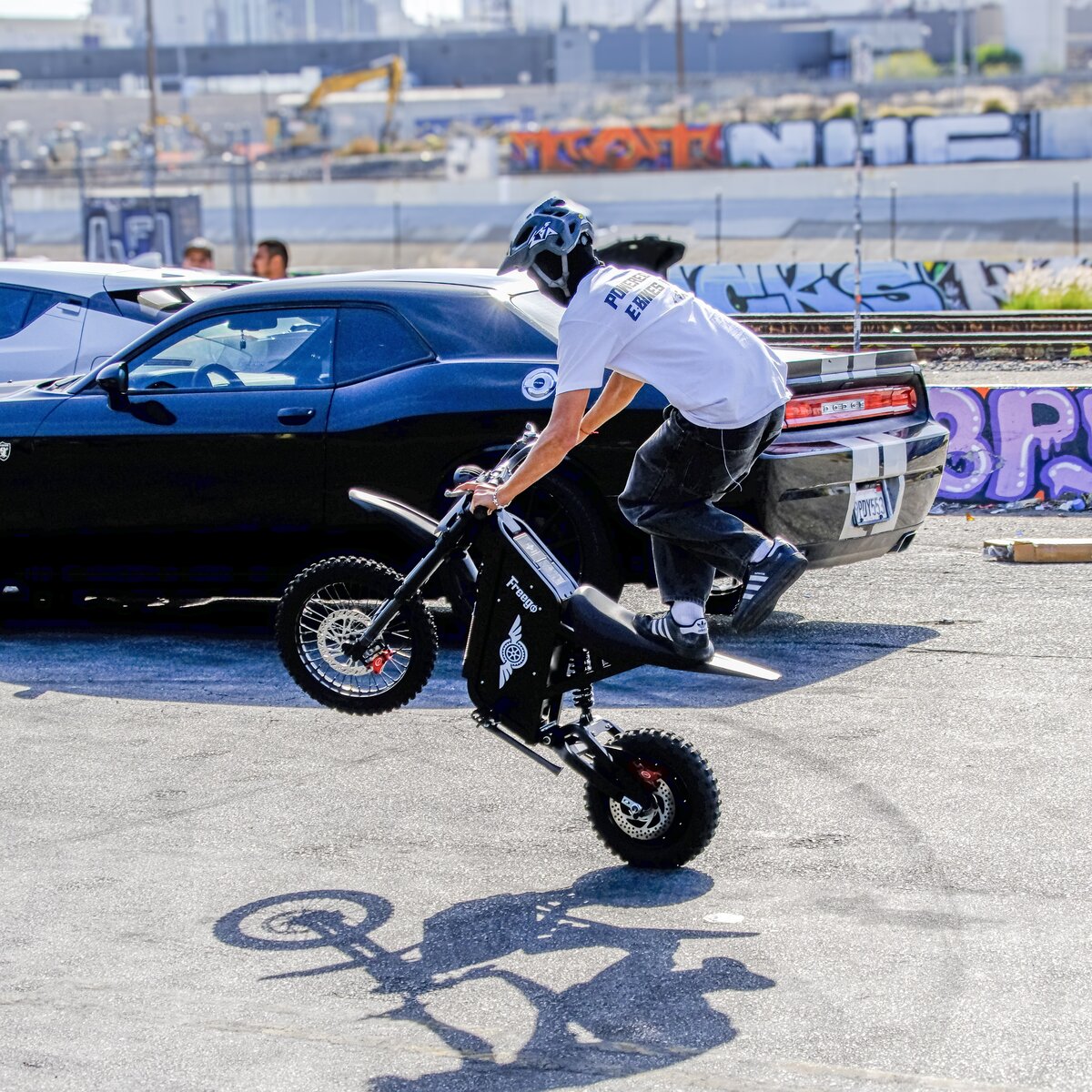 Freego X0 electric mini bike — rider doing a wheelie on pavement