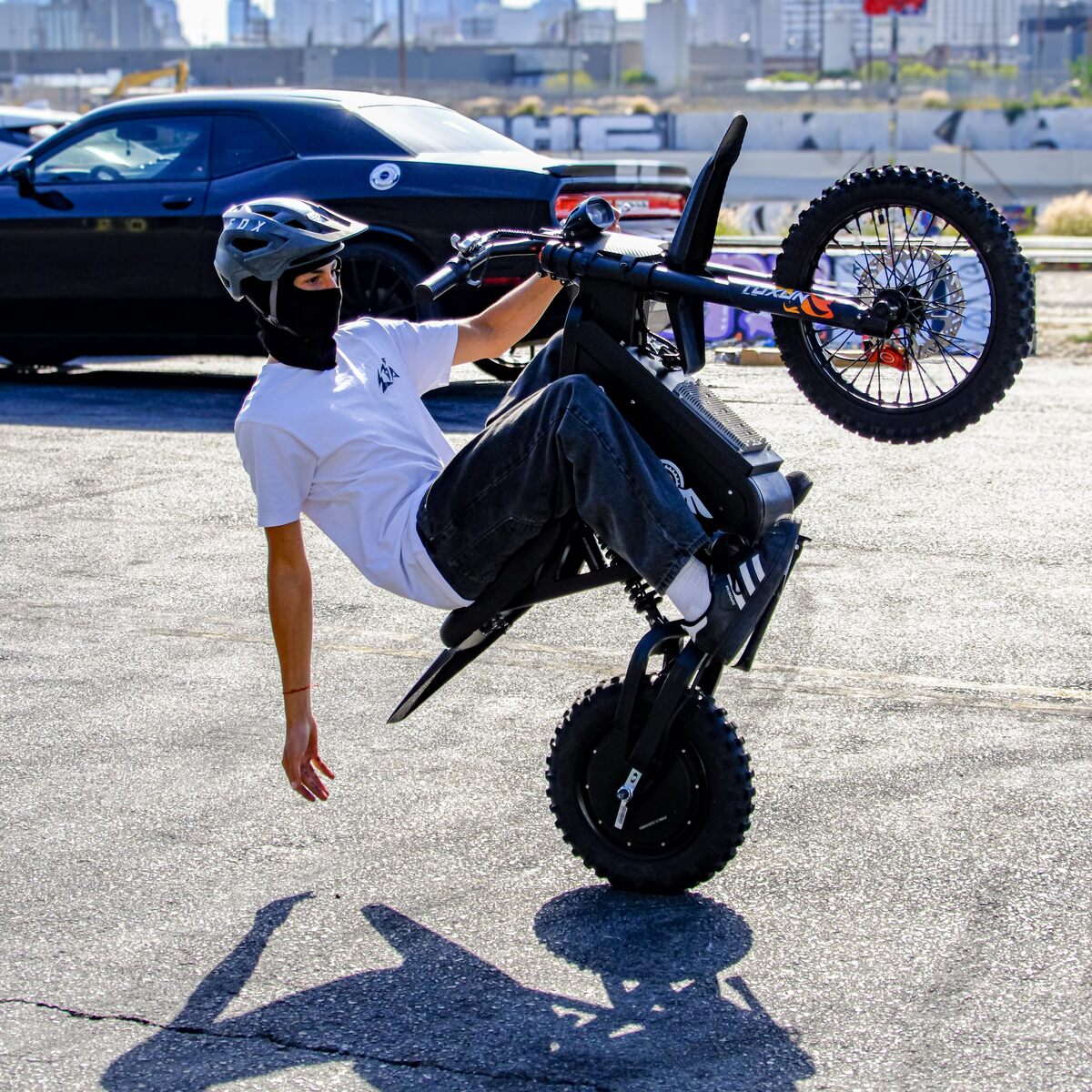 Freego X0 electric mini bike performing a wheelie on pavement