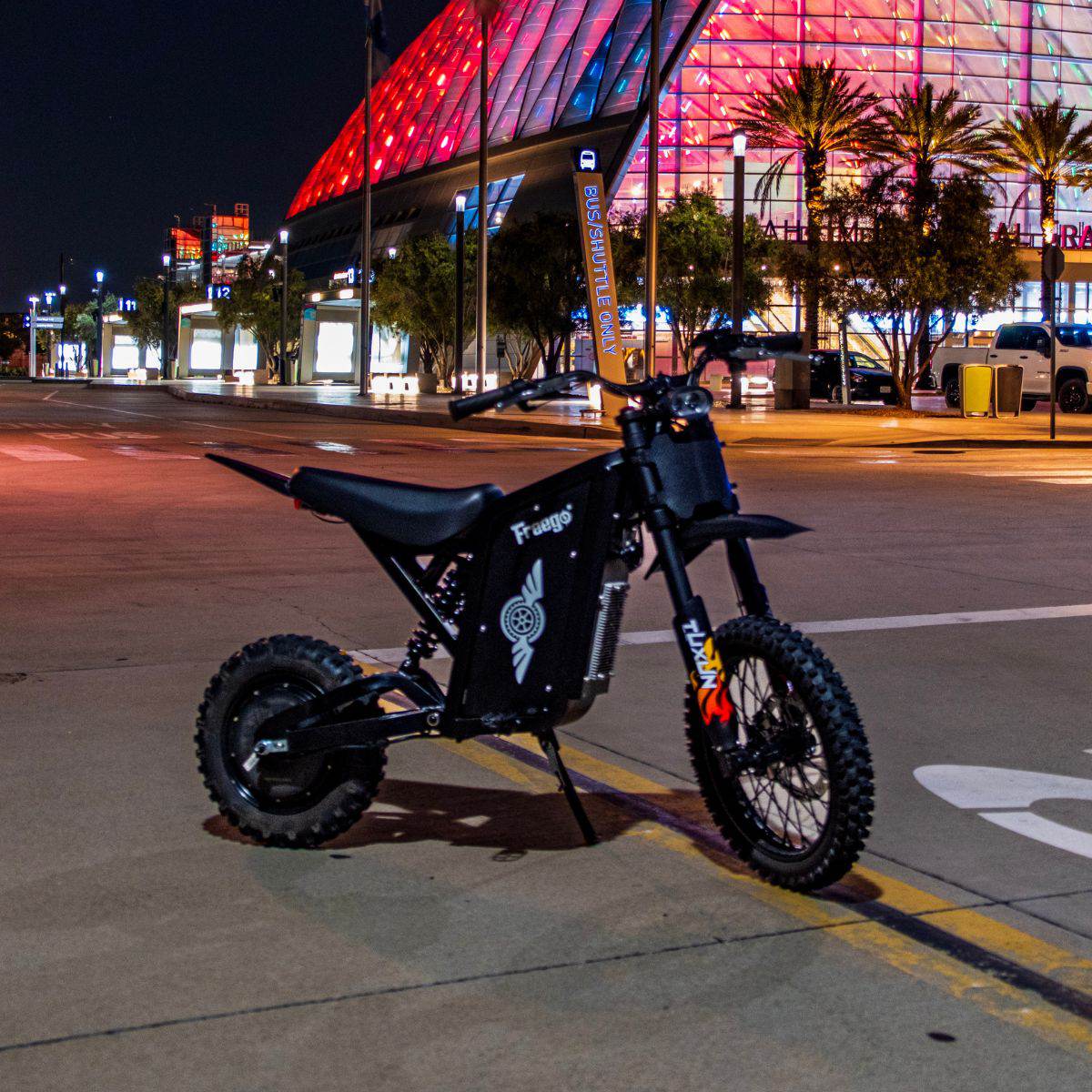Freego X0 Mini ebike on a city street at night with colorful building lights in the background