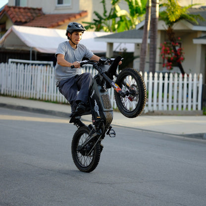 Freego X1 electric dirt bike wheelie stunt side view action shot