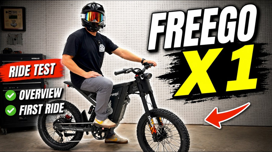 Man wearing a black helmet sitting on a black Freego X1 electric bike in a workshop, with “RIDE TEST,” “OVERVIEW,” and “FIRST RIDE” text overlays.