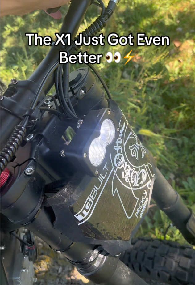 Close-up of a Freego X1 handlebar light labeled “WEBUILT X1.”