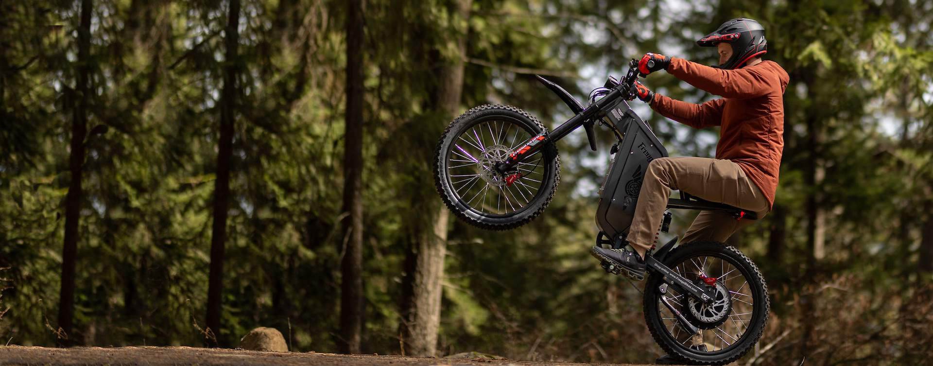 Person riding a Freego X2 Pro dirt bike in a forest