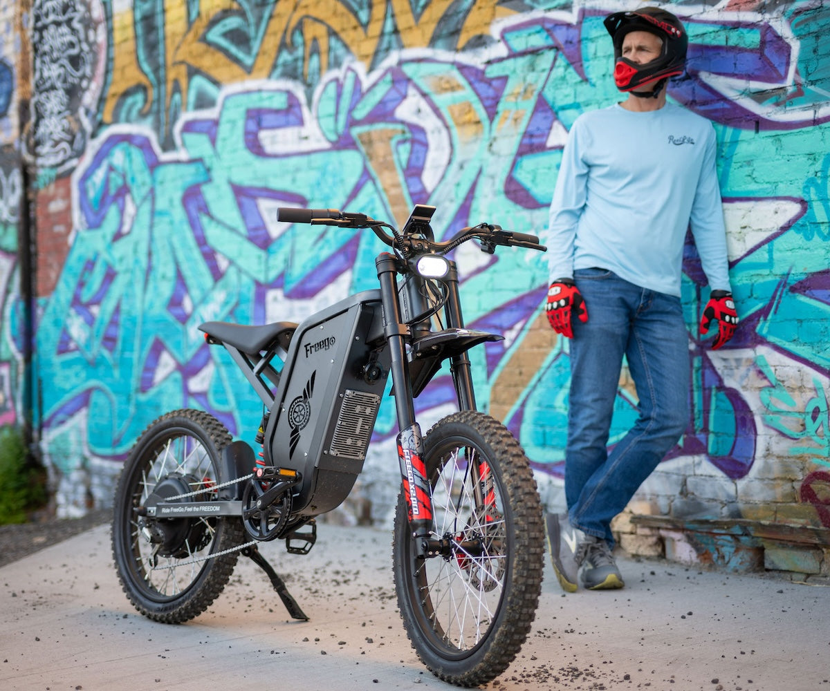 Freego X2 Pro electric bike parked by the roadside with a person standing beside it