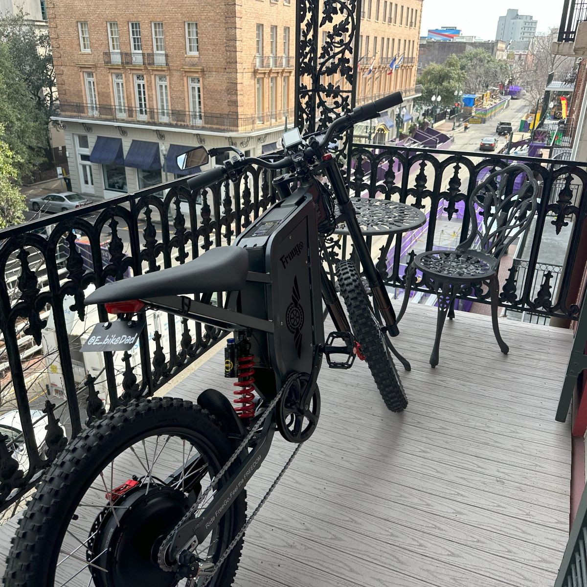 Electric bike on a balcony with a city street view in the background
