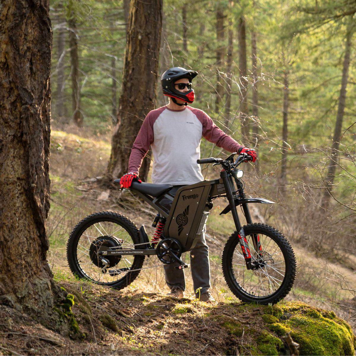 Person with a Freego X2 Pro dirt ebike in a forest setting