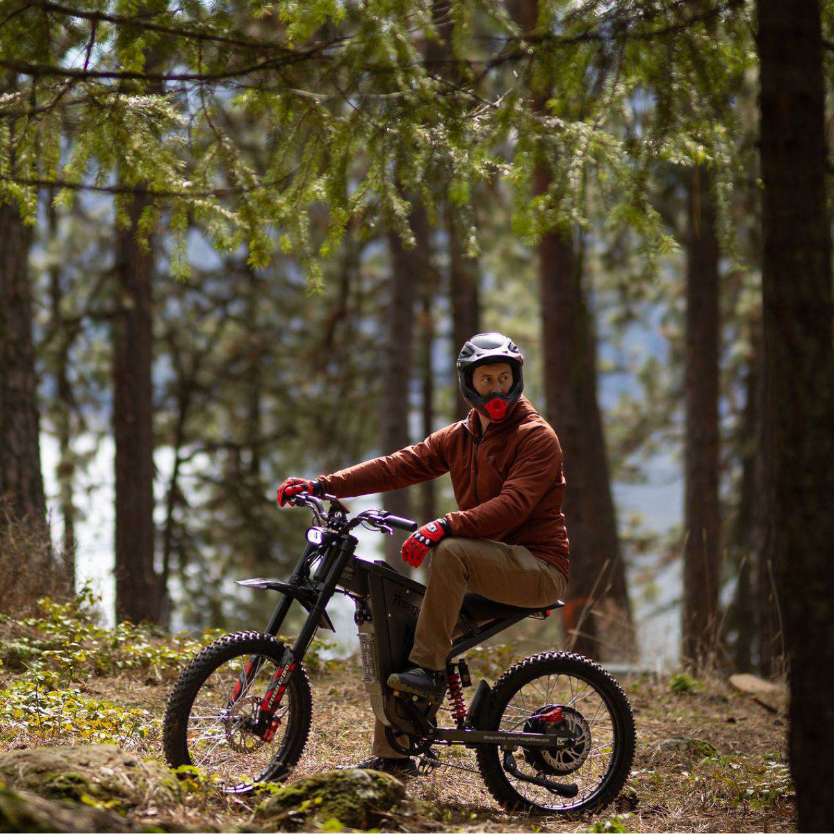 Person riding a Freego X2 Pro dirt ebike in a forest