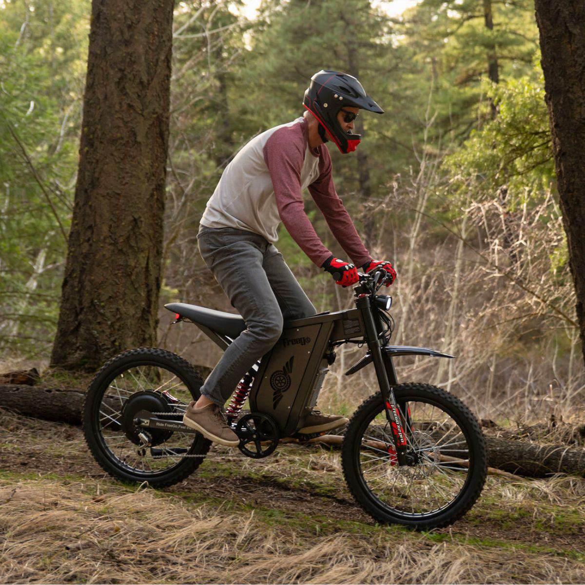 Person riding a Freego X2 Pro dirt ebike in a forest setting