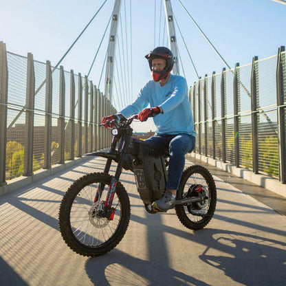 Person riding a Freego X2 Pro dirt ebike on a bridge