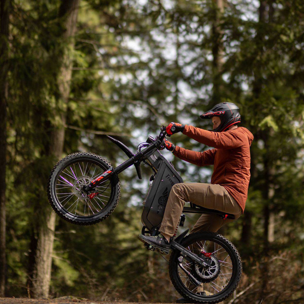 Person riding a Freego X2 Pro dirt ebike in a forest setting