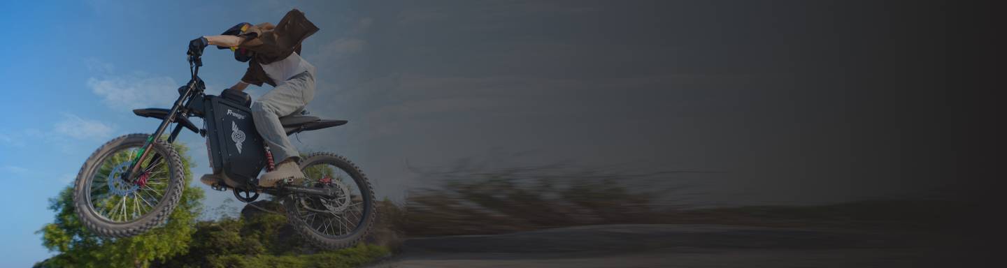 Person riding a Freego X3 dirt bike on a track with a blurred background