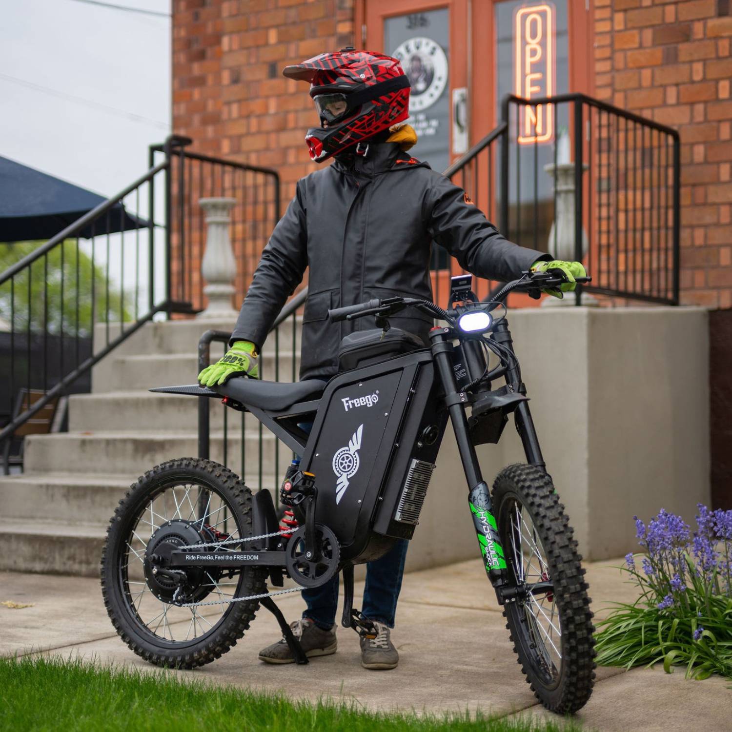 Freego X3 Pro electric dirt bike viewed from the front in an urban setting.