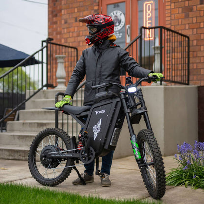 Freego X3 Pro electric dirt bike viewed from the front in an urban setting.