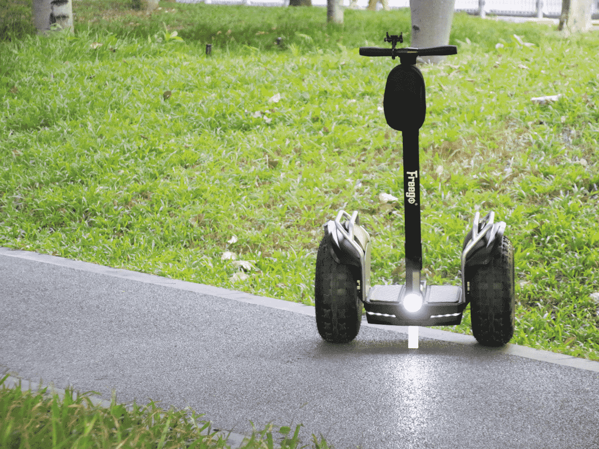 Segway on a paved path with grass in the background