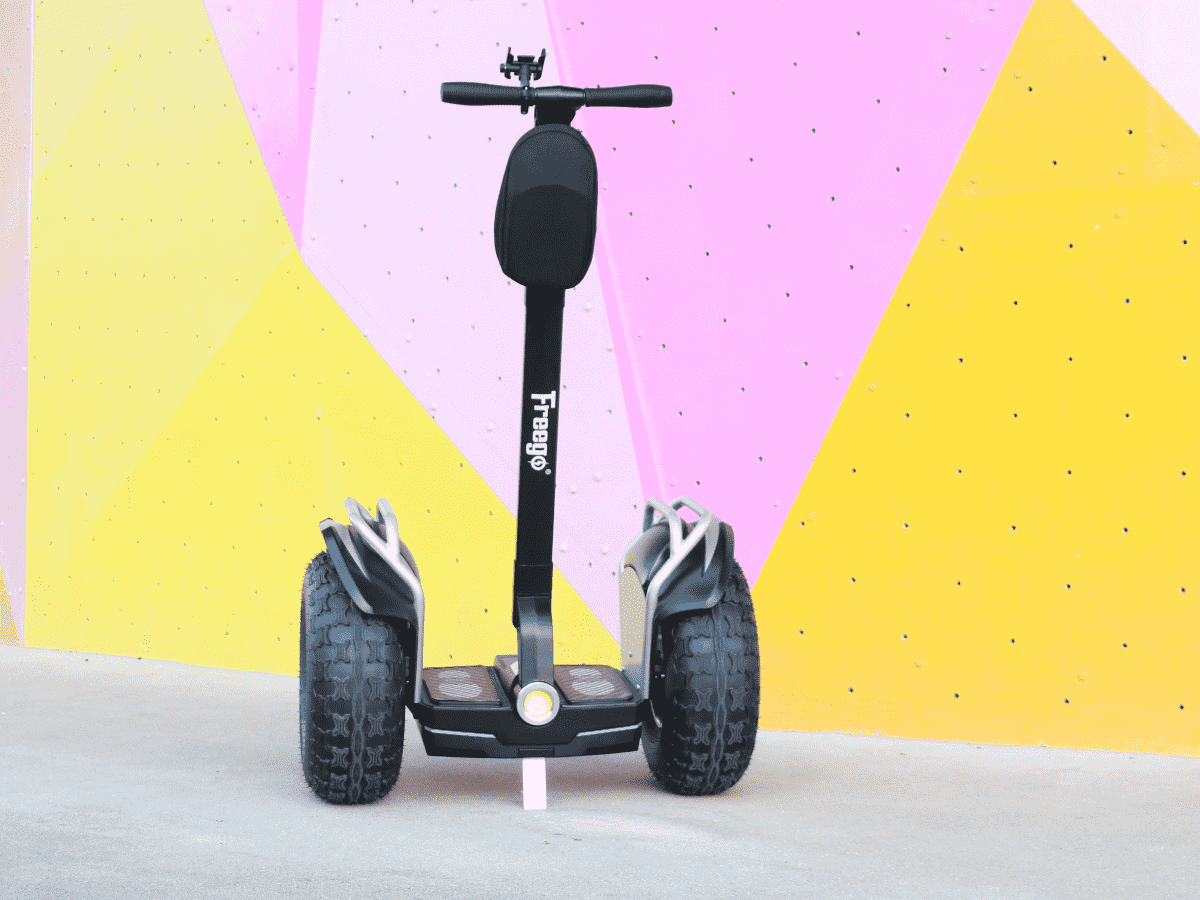 Black Segway-style scooter with 'Freewheel' branding against a colorful geometric background