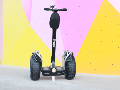 Black Segway-style scooter with 'Freewheel' branding against a colorful geometric background