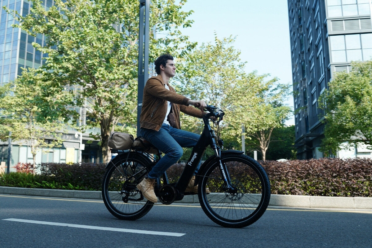 A man rides freego A1 through a modern urban setting, enjoying everyday commute.