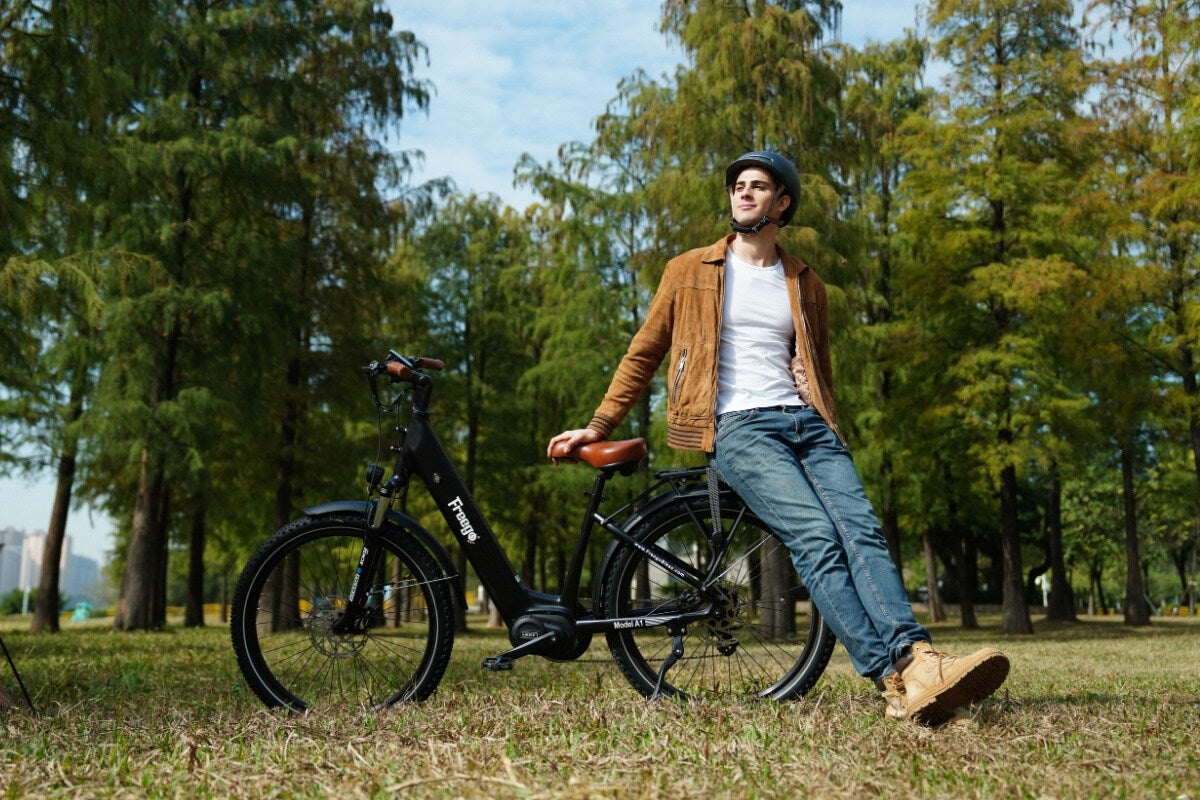 Man standing next to freego A1 in a park with trees and grass.