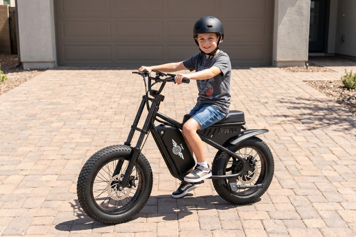Child riding a black freego m1 electric bike on a driveway
