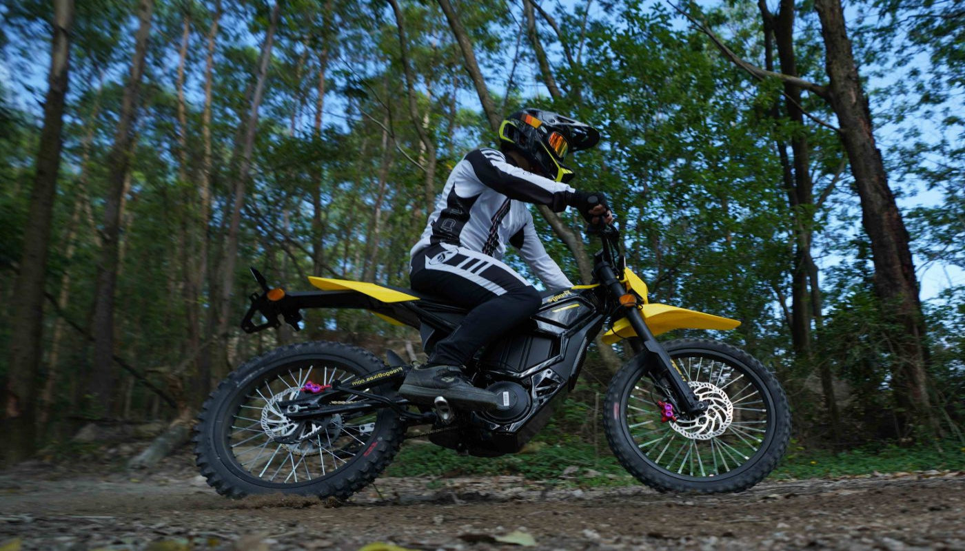 Person on a dirt bike in a forest setting
