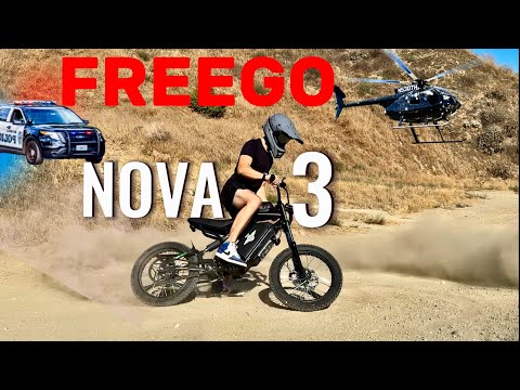 Person riding a bike with 'Freego Nova 3' text and police car and helicopter in the background.
